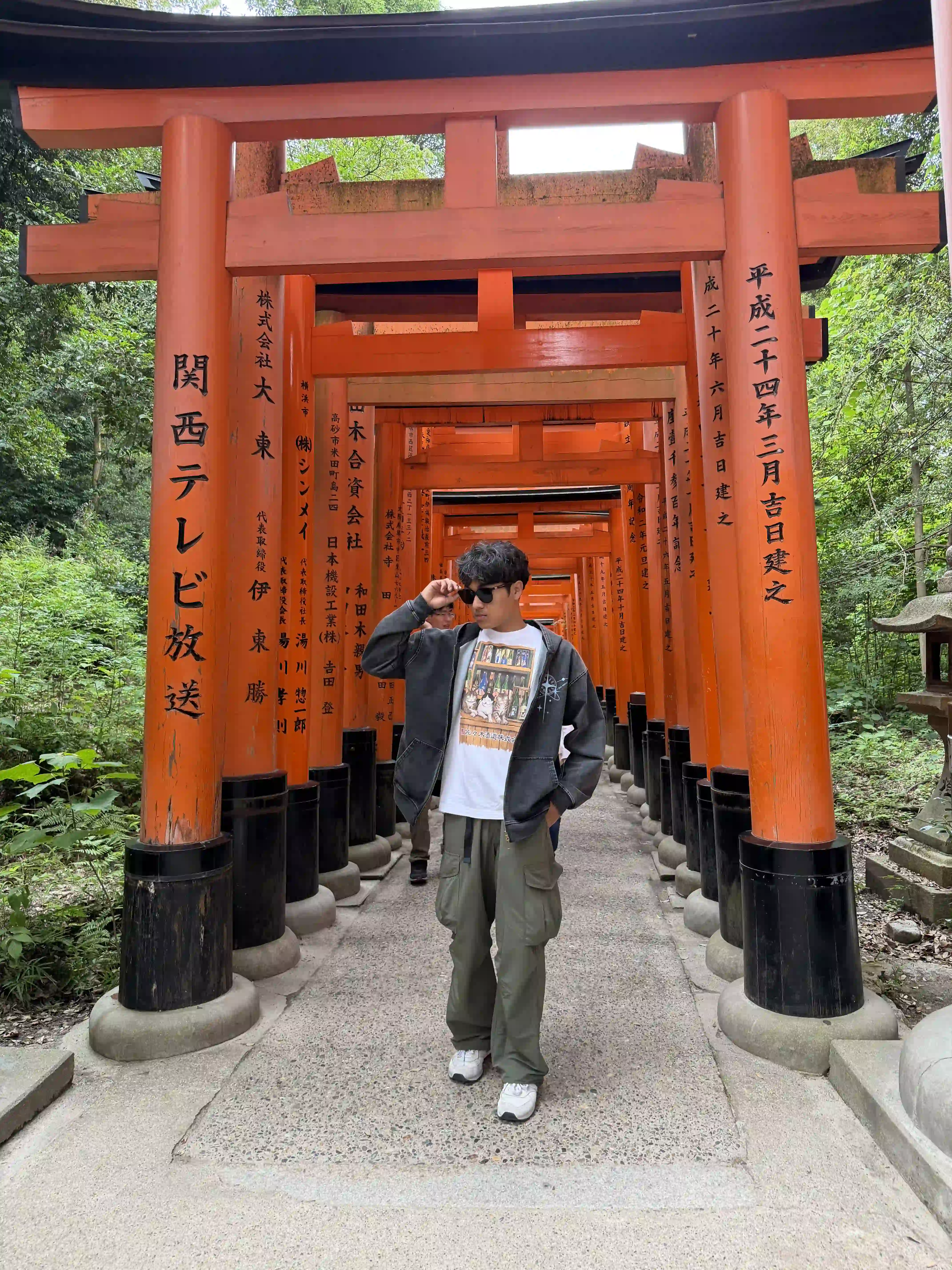 Sonav standing beneath the torii gates in Kyoto